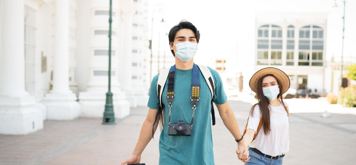 Image: Couple in face masks on vacation in Mexico City. (photo via Antonio_Diaz / iStock / Getty Images Plus)
