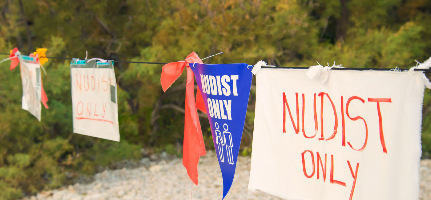 Image: Nudists only sign. (Photo Credit: AygulSarvarova / iStock / Getty Images Plus)