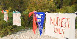 Nudists only sign.