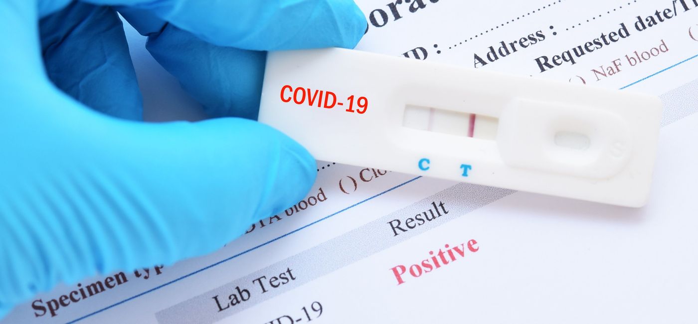 Image: Positive test result by using rapid test device for COVID-19. (photo via jarun011 / iStock / Getty Images Plus)
