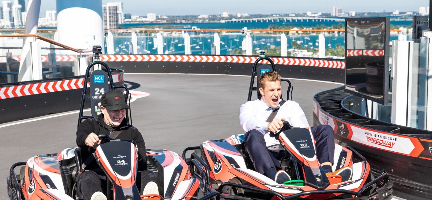 Image: Jeff Gordon and Rob Gronkowski race on the Norwegian Encore's go-kart track. (photo via Norwegian Cruise Line)