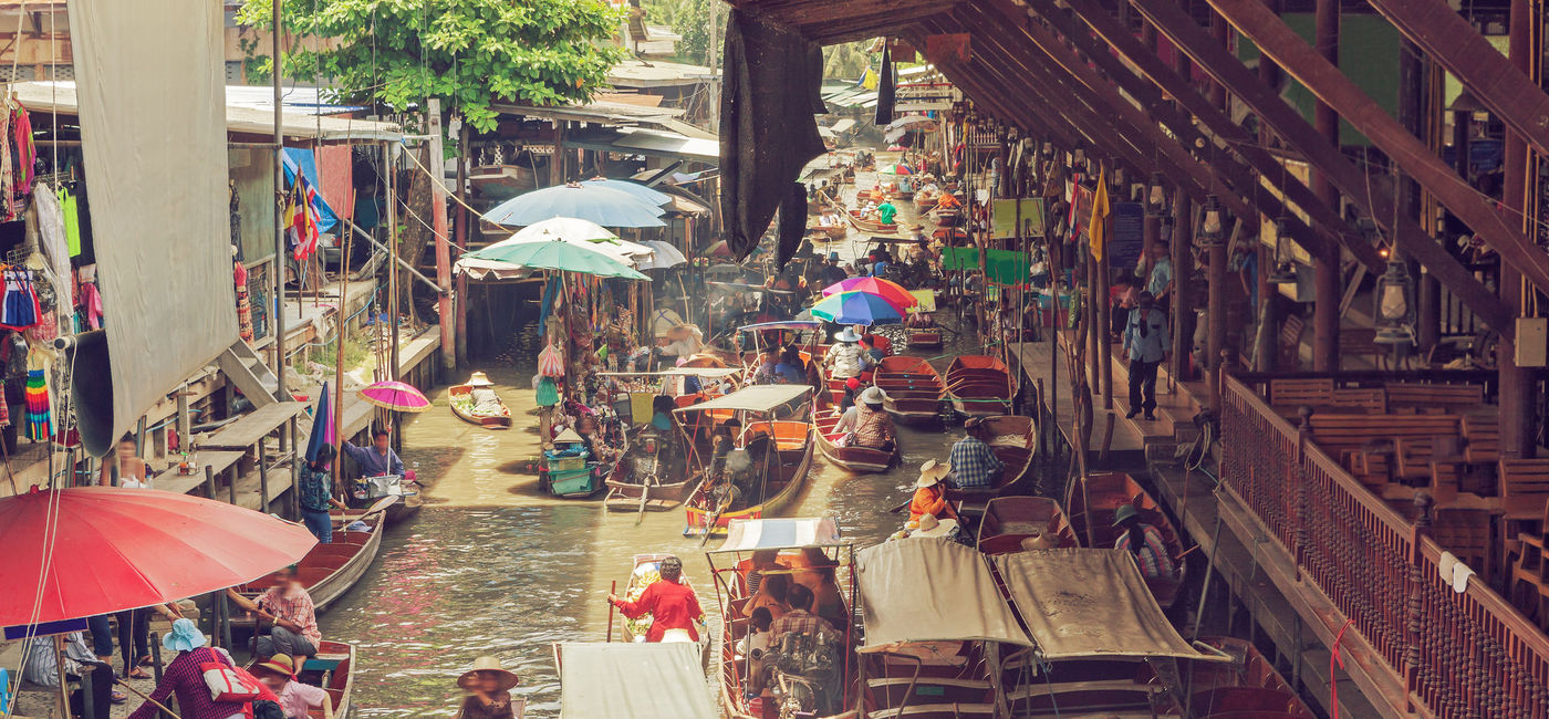 Image: PHOTO: Vendors and customers on a Thai floating market. (photo via  iStock / Getty Images Plus /  carloscastilla)