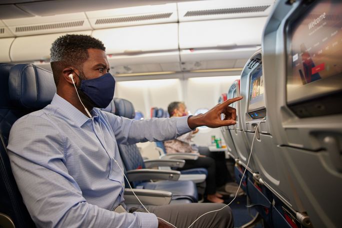 A passenger enjoying in-flight entertainment A passenger enjoying in-flight entertainment