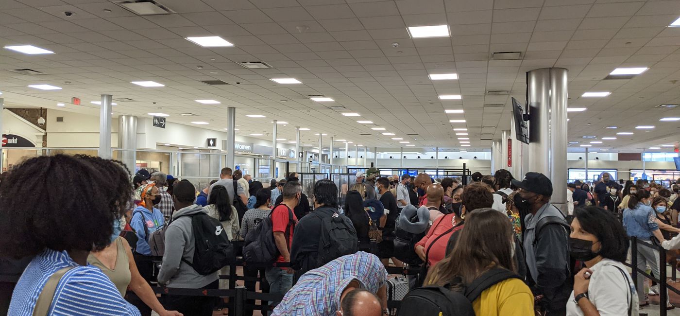 Image: Travelers wait in the airport security line. (photo by Eric Bowman)