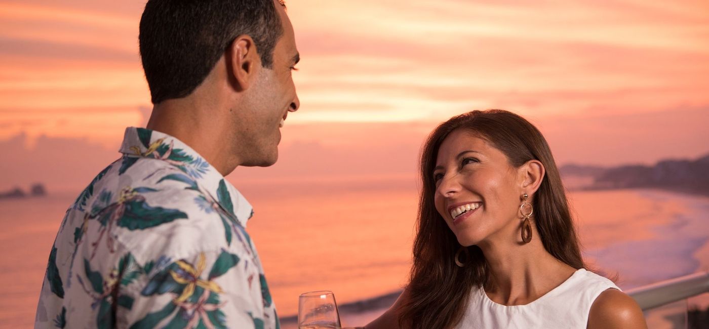 Image: ouple enjoying champagne on the terrace. (photo courtesy of AMR Collection) (AMResorts)