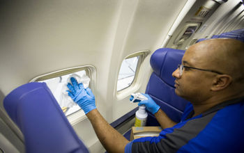 Southwest employee cleaning plane.