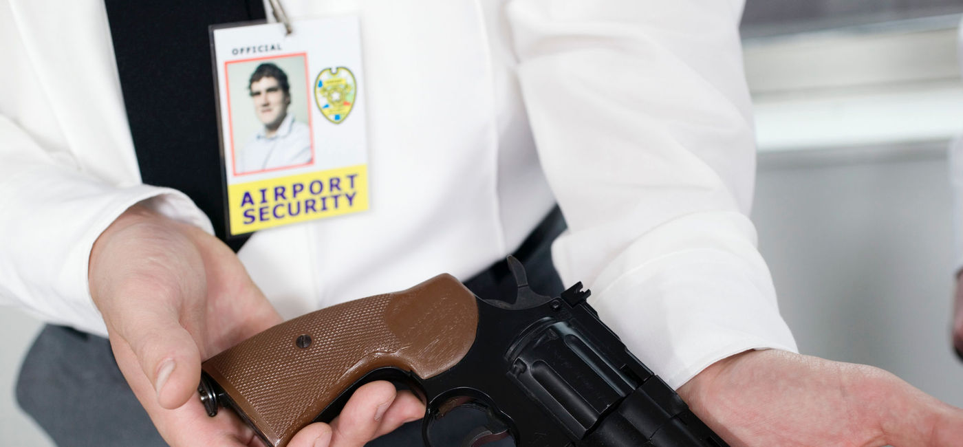 Image: PHOTO: A handgun at an airport security checkpoint. (Photo via iStock/Getty Images Plus/Creatas)