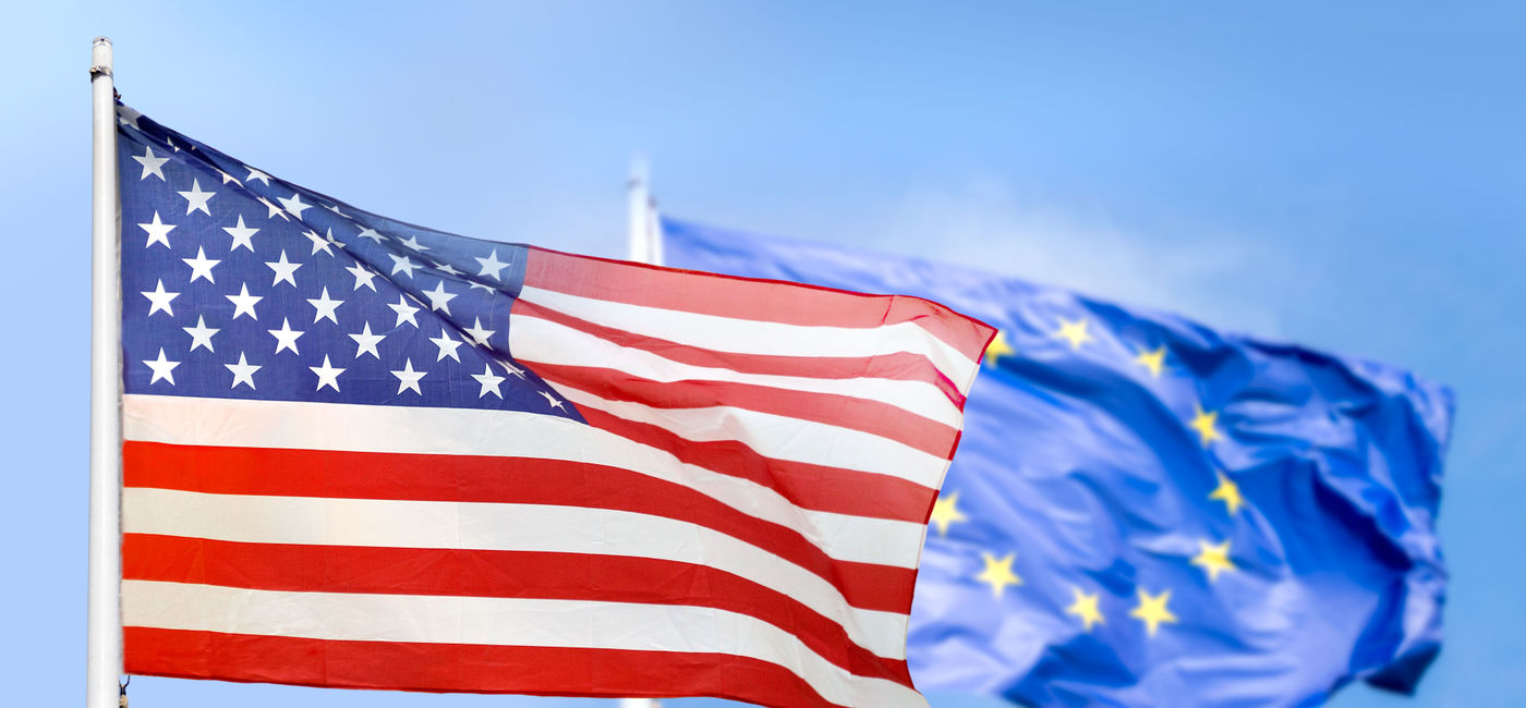 Image: European Union and USA flags. (photo via Cunaplus_M.Faba / iStock / Getty Images Plus)