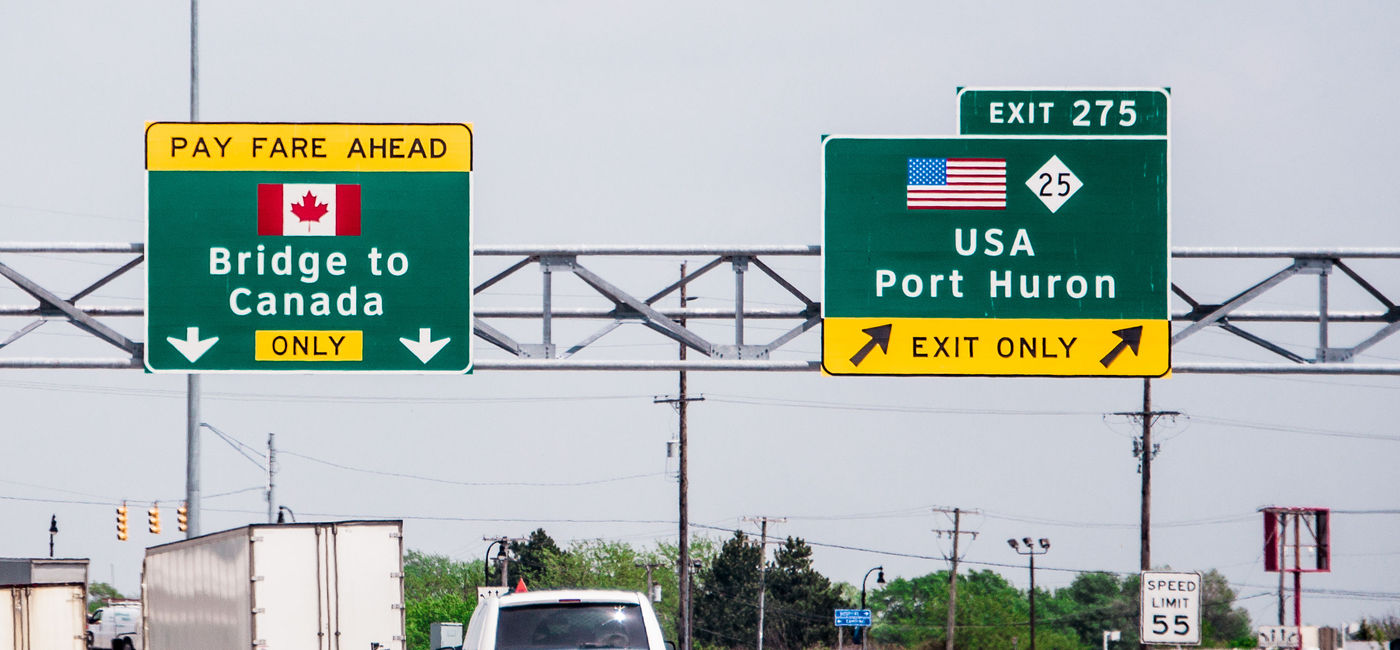 Image: Bridge to Canada sign. (photo via eyfoto / iStock / Getty Images Plus)