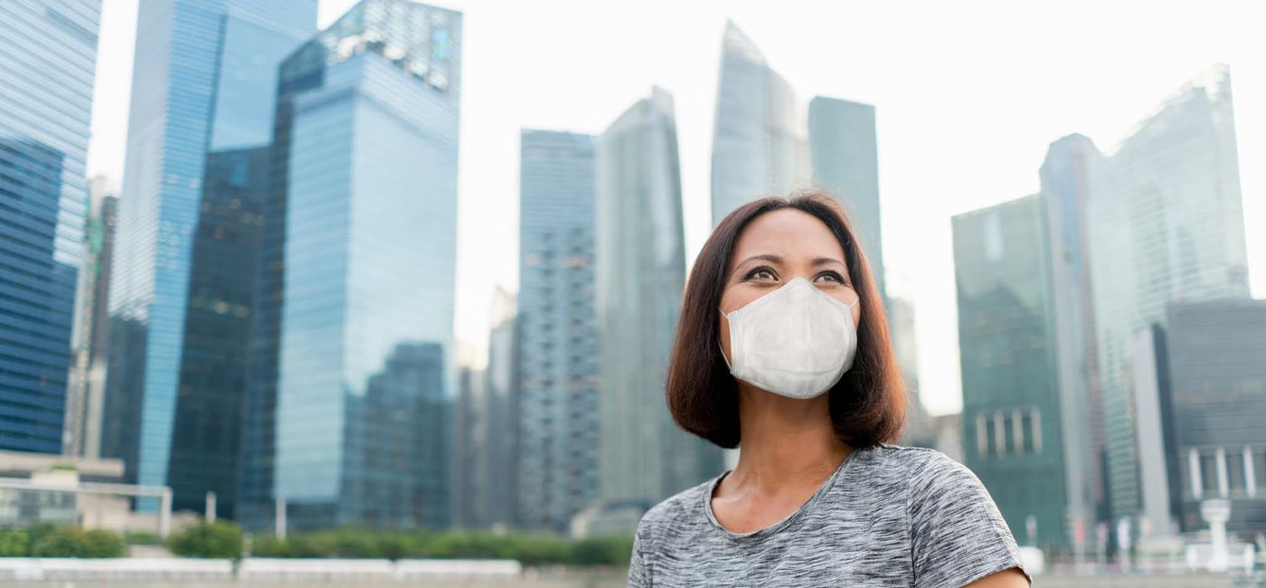 Image: PHOTO: Businesswoman in Singapore wearing a face mask. (photo via andresr / E+)