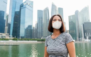 Businesswoman in Singapore wearing a face mask.