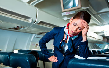 flight attendant, stewardess, plane, cabin, exhausted, frustrated, headache