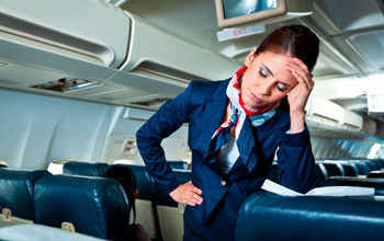 flight attendant, stewardess, plane, cabin, exhausted, frustrated, headache