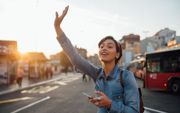 Woman waiving to Uber driver.