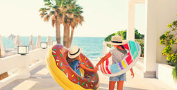 Two young girls with inflatable toys 