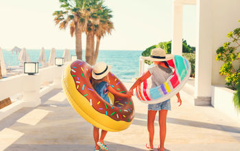 Two young girls with inflatable toys 