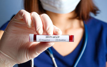 Nurse holding test tube for novel coronavirus.
