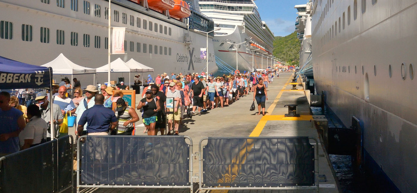 Image: Cruise passengers in line for dockside security check before boarding their ship. (photo via iStock Editorial/Getty Images Plus/joesboy)