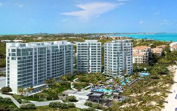 White hotel building on white sand beach with turquoise ocean