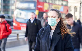 Young woman in London wearing a hygenic mask.