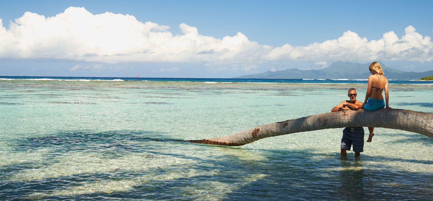 Image: A couple lounge in the water in Tahiti. (photo via Windstar Cruises) ((photo via Windstar Cruises))