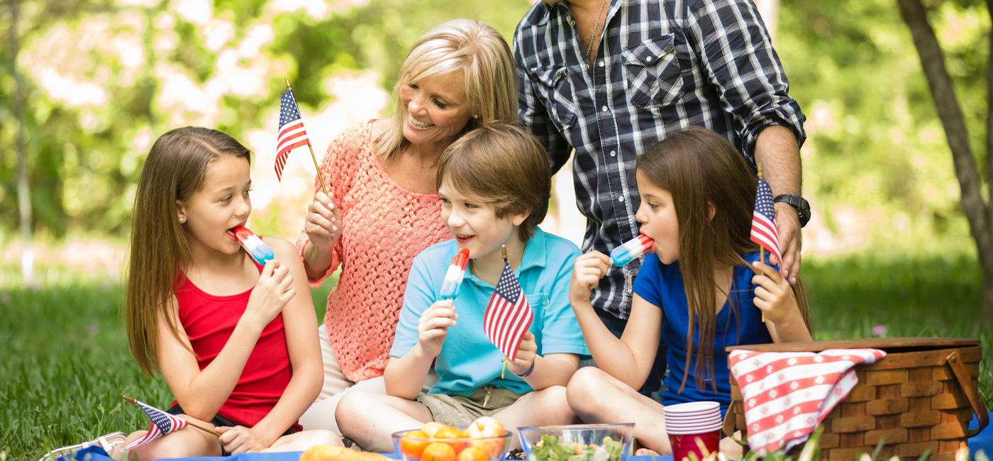 Image: Family celebrating a U.S. national holiday with an outdoor picnic. (Photo via iStock/Getty Images/fstop123)