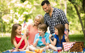 Family celebrating a U.S. national holiday with an outdoor picnic.