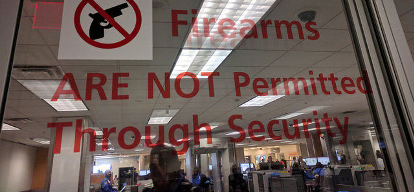 Image: PHOTO: No guns allowed on planes sign, TSA checkpoint, Atlanta International Airport. (photo via Flickr/Cory Doctorow)