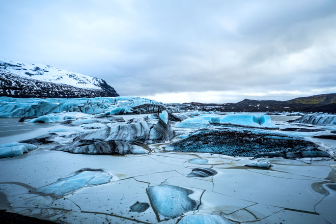 Glacier in Iceland - Blue icebergs floating in the lagoon