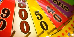 Close-up of a spinning wheel-of-fortune arcade game.