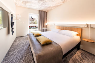 Hotel room with natural light and fresh furnishings