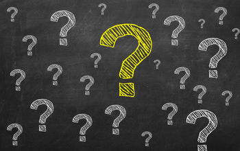 yellow chalk question mark on the blackboard