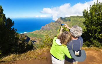 Tourist couple at Waimea Canyon State Park, Kauai, Hawaii