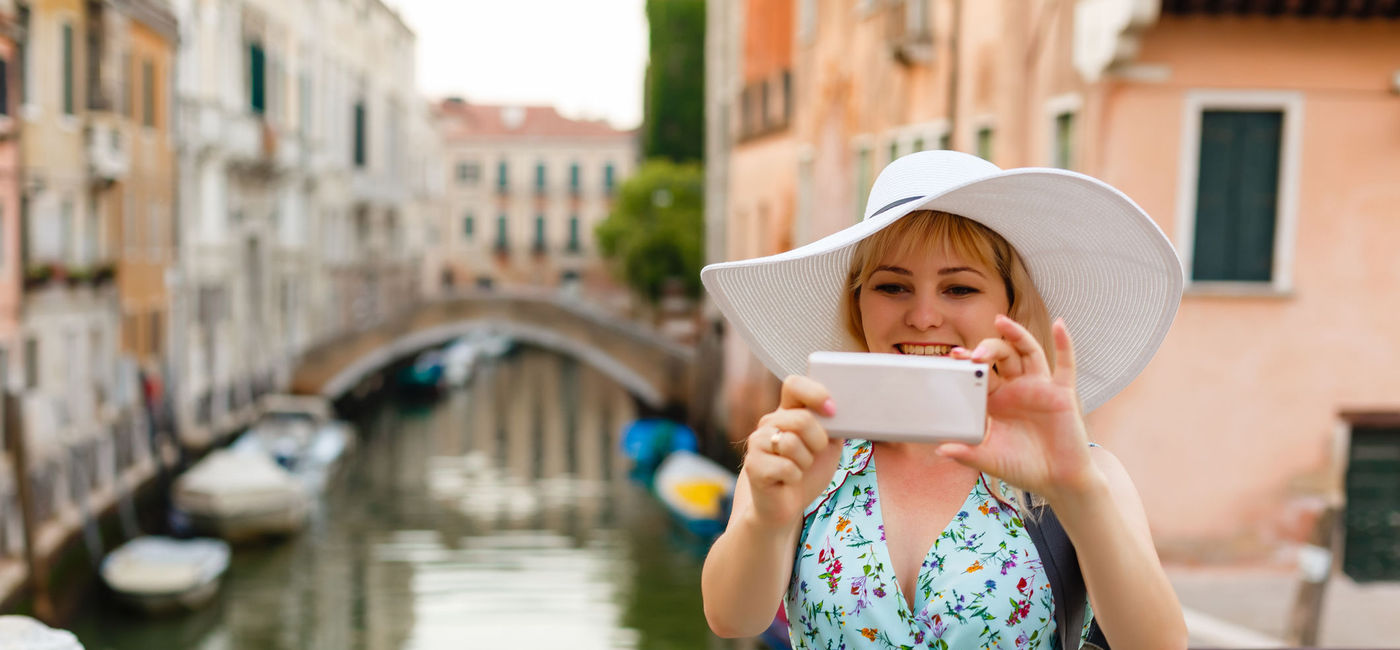 Image: PHOTO: Tourist taking photos in Venice, Italy. (Photo via iStock/Getty Images Plus/Sinenkiy)
