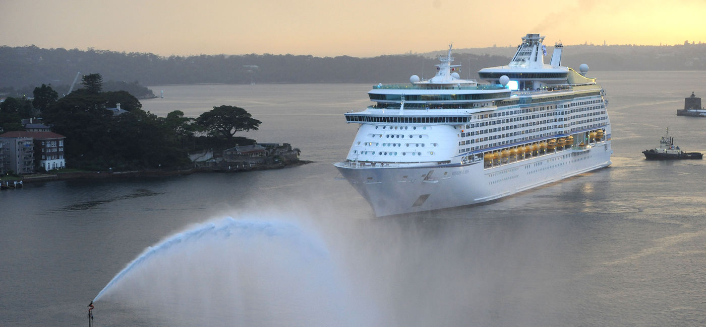 Image: Voyager of the Seas moving through a bay. (Photo via Royal Caribbean International)