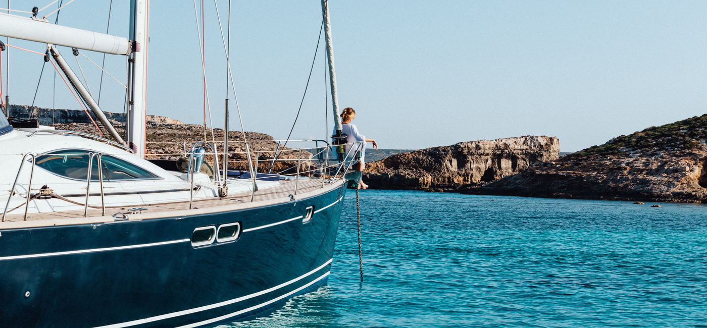 Photo: A woman enjoying a private yacht cruise in the Blue Lagoon. (photo courtesy of Malta Tourism Authority)