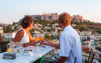 Travelers enjoying a drink in Greece.