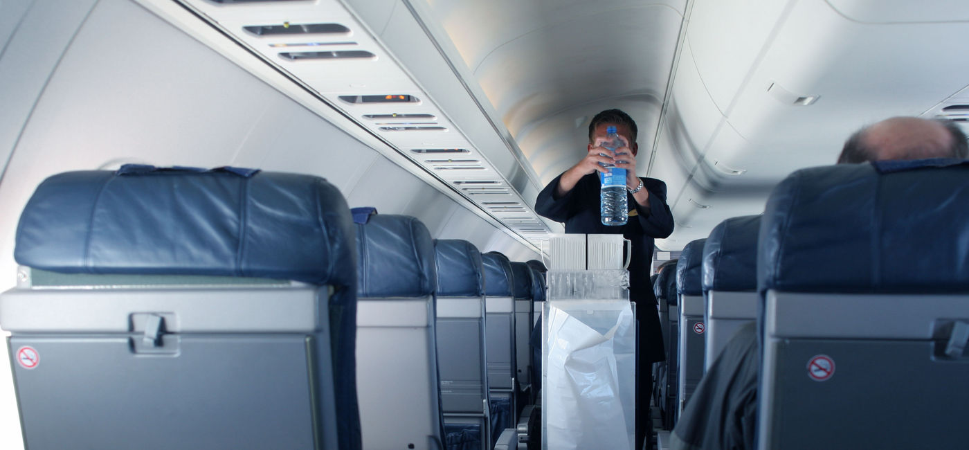 Image: Flight attendant with beverage cart. (Photo via Getty Images Plus / iStock / Instants)