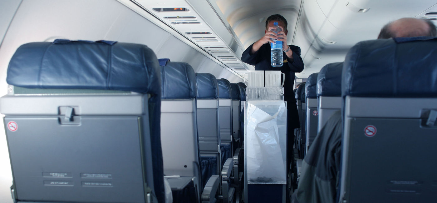 Image: PHOTO: Flight attendant with beverage cart. (Photo via Getty Images Plus / iStock / Instants)