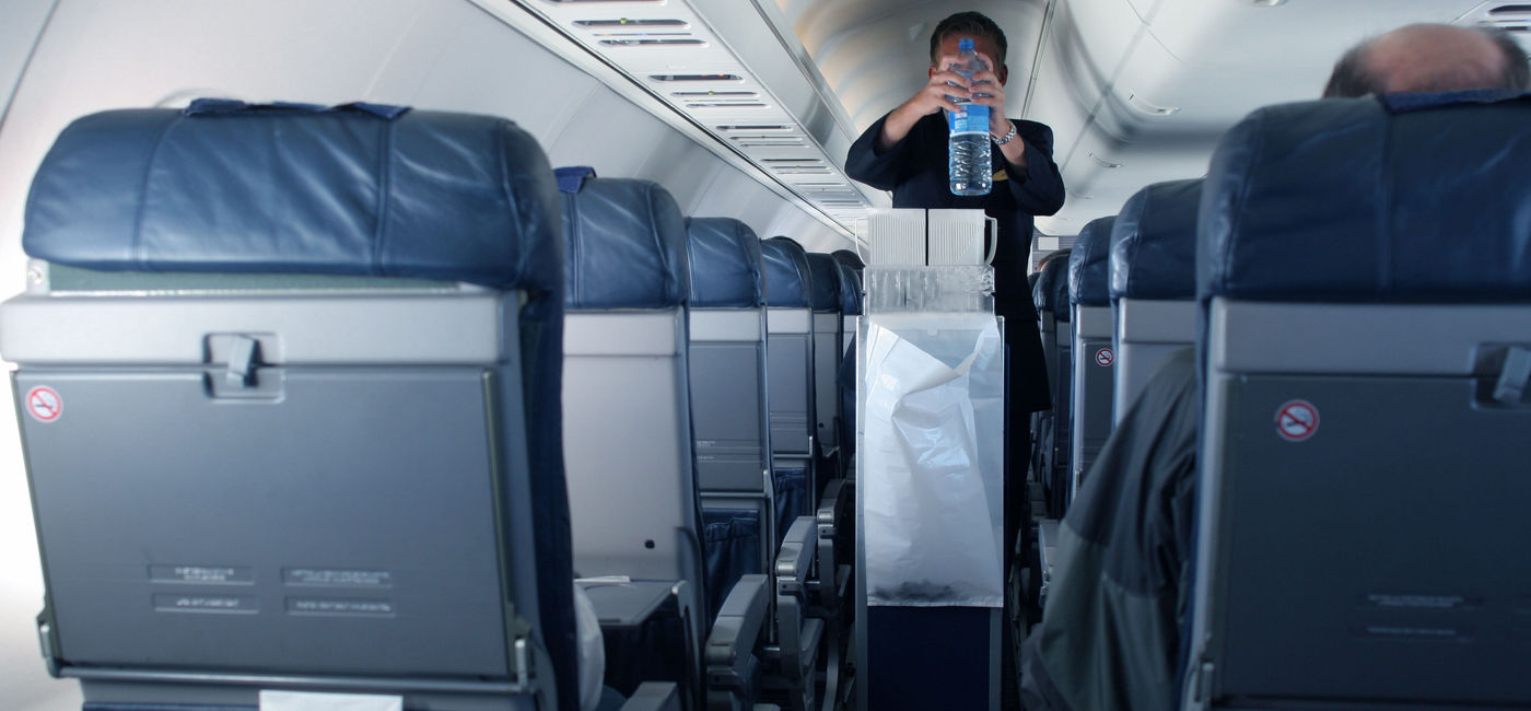 Image: PHOTO: Flight attendant with beverage cart. (Photo via Getty Images Plus / iStock / Instants)