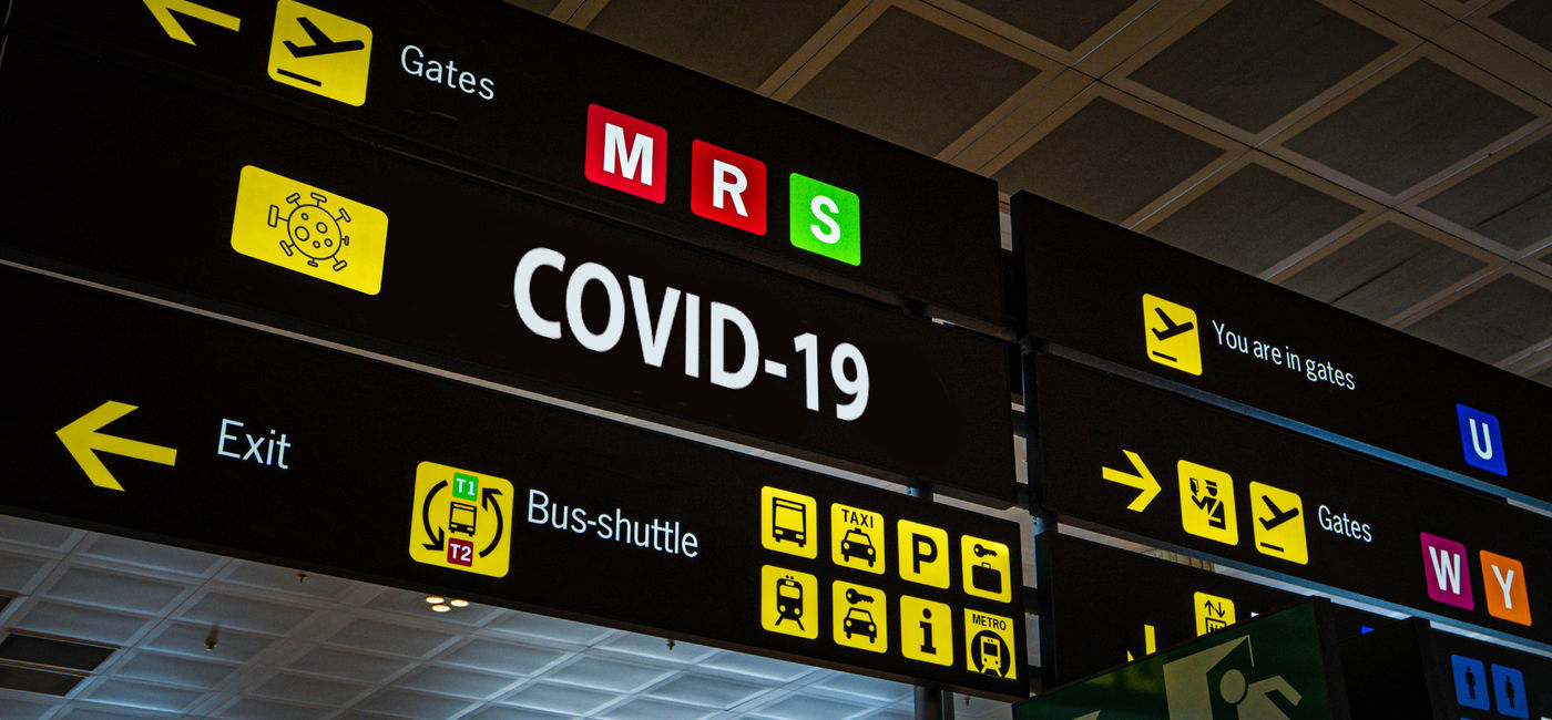 Image: PHOTO: Airport information panel emblazoned with "Covid-19". (Photo via iStock/Getty Images Plus/Tanaonte)