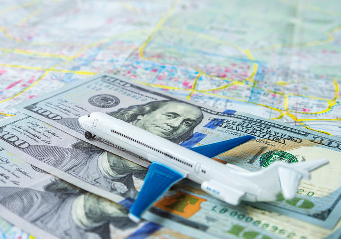 Airline ticket pricing concept. Airlines, airfare, airplane, pricing, cost, cash, bills, money, dollars