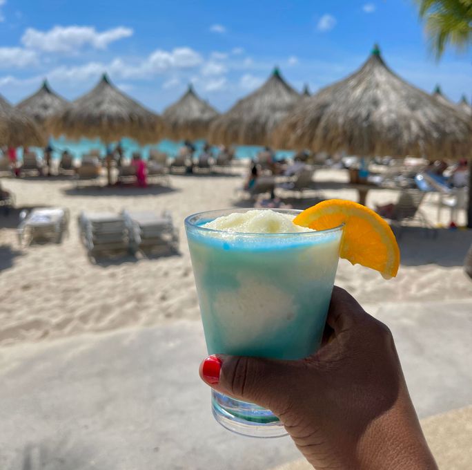 Enjoying a drink on a beach in Aruba Enjoying a drink on a beach in Aruba
