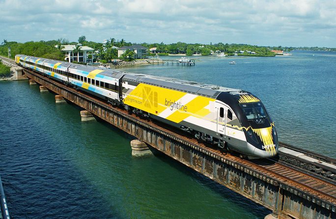 Bright Blue, one of Brightline's eco-friendly trains, on a bridge in south Florida.