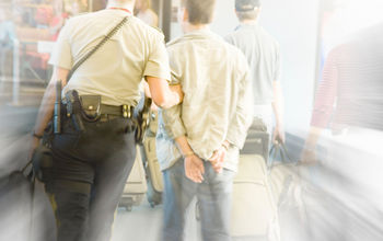 Airport security escorting a man off of an airplane
