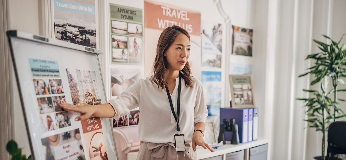 Image: Travel advisor sharing information. (photo via South_agency / getty images)