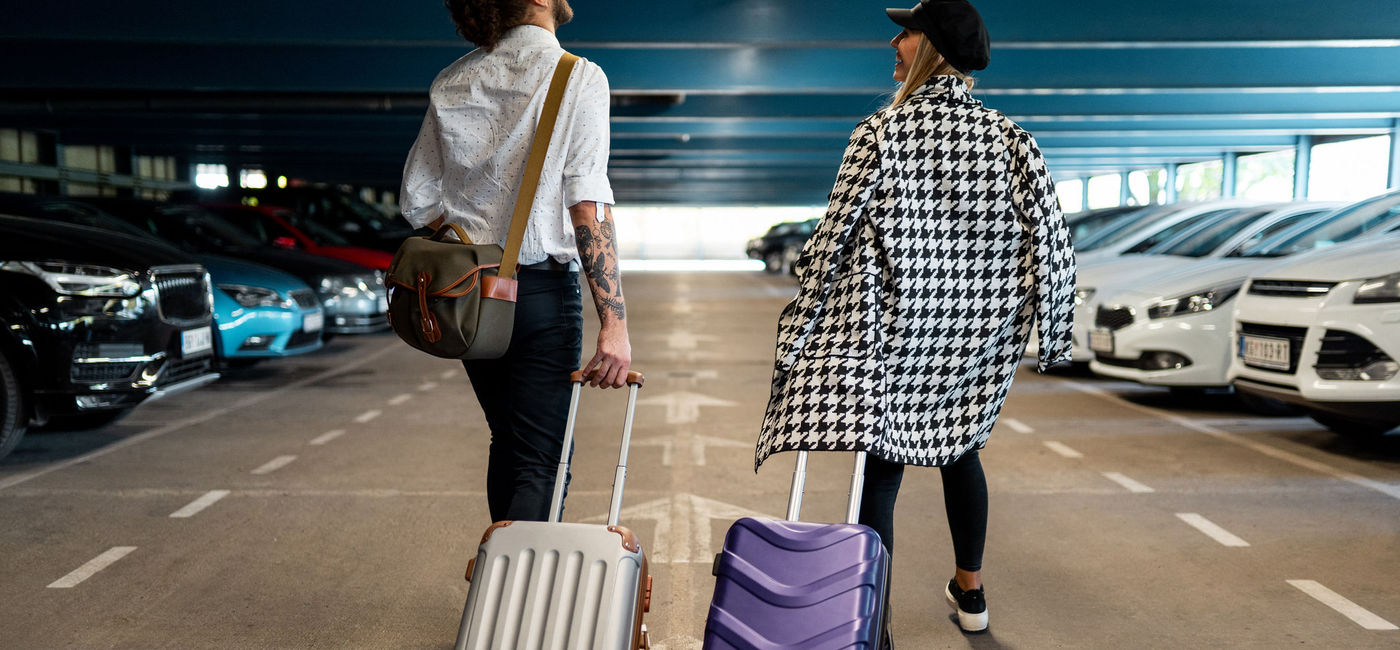 Image: Couple arriving to the airport. (Photo Credit: freemixer/E+)