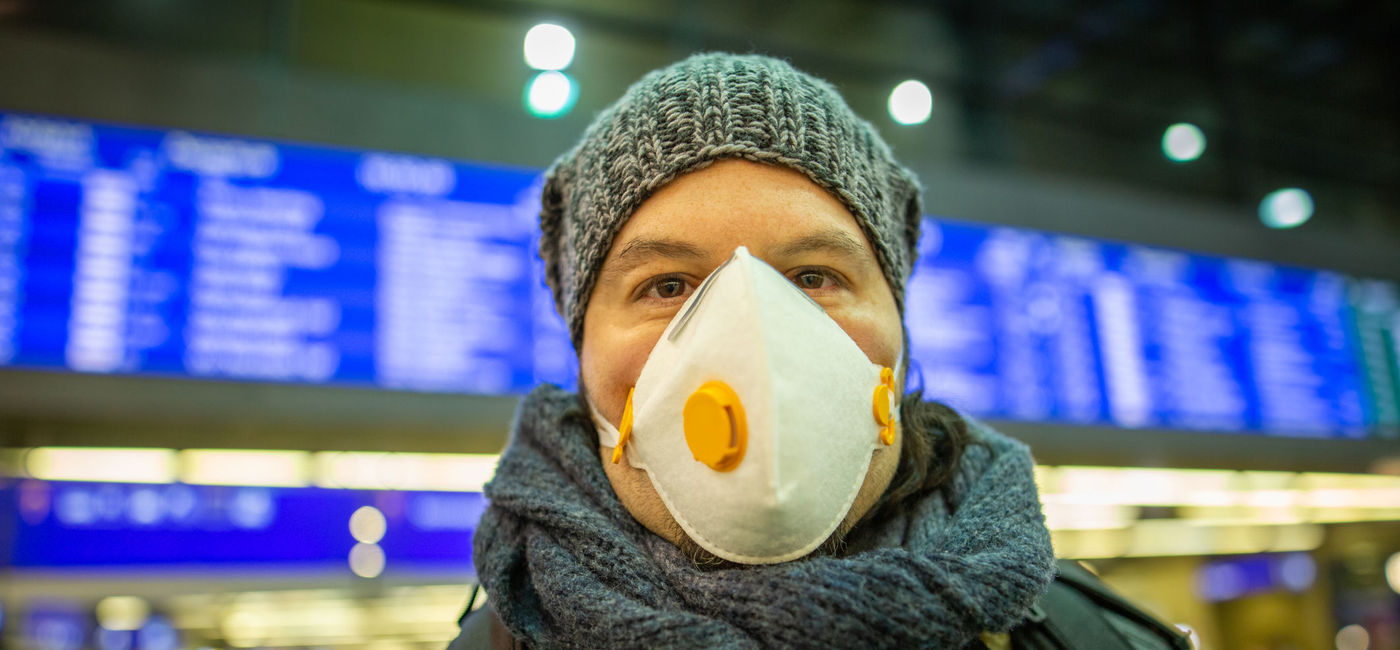 Image: PHOTO: Man wearing a mask at a train station. (photo via TeamDAF/iStock/Getty Images Plus)