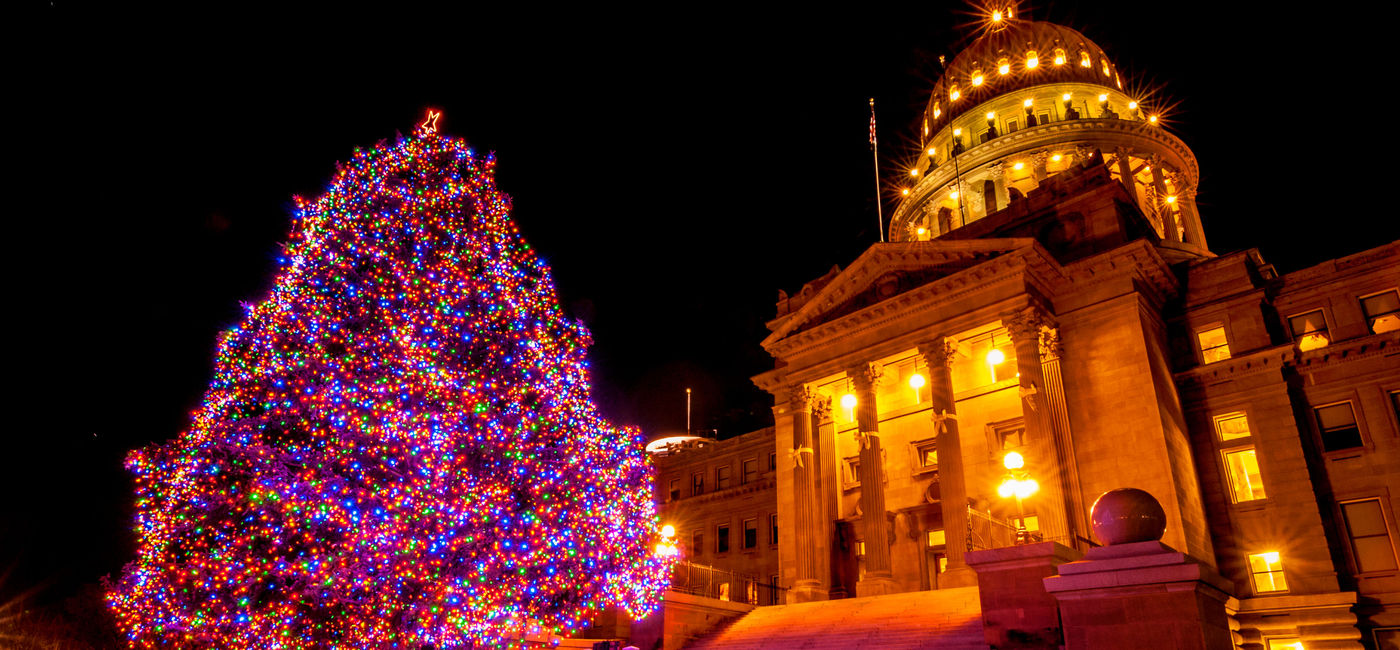 Image: Beautiful Christmas tree decorated with colorful lights in front of Idaho State Capitol building in Boise, Idaho, USA (Photo via  vkbhat / iStock / Getty Images Plus)