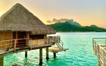 Overwater bungalows and mountain on Bora Bora lagoon